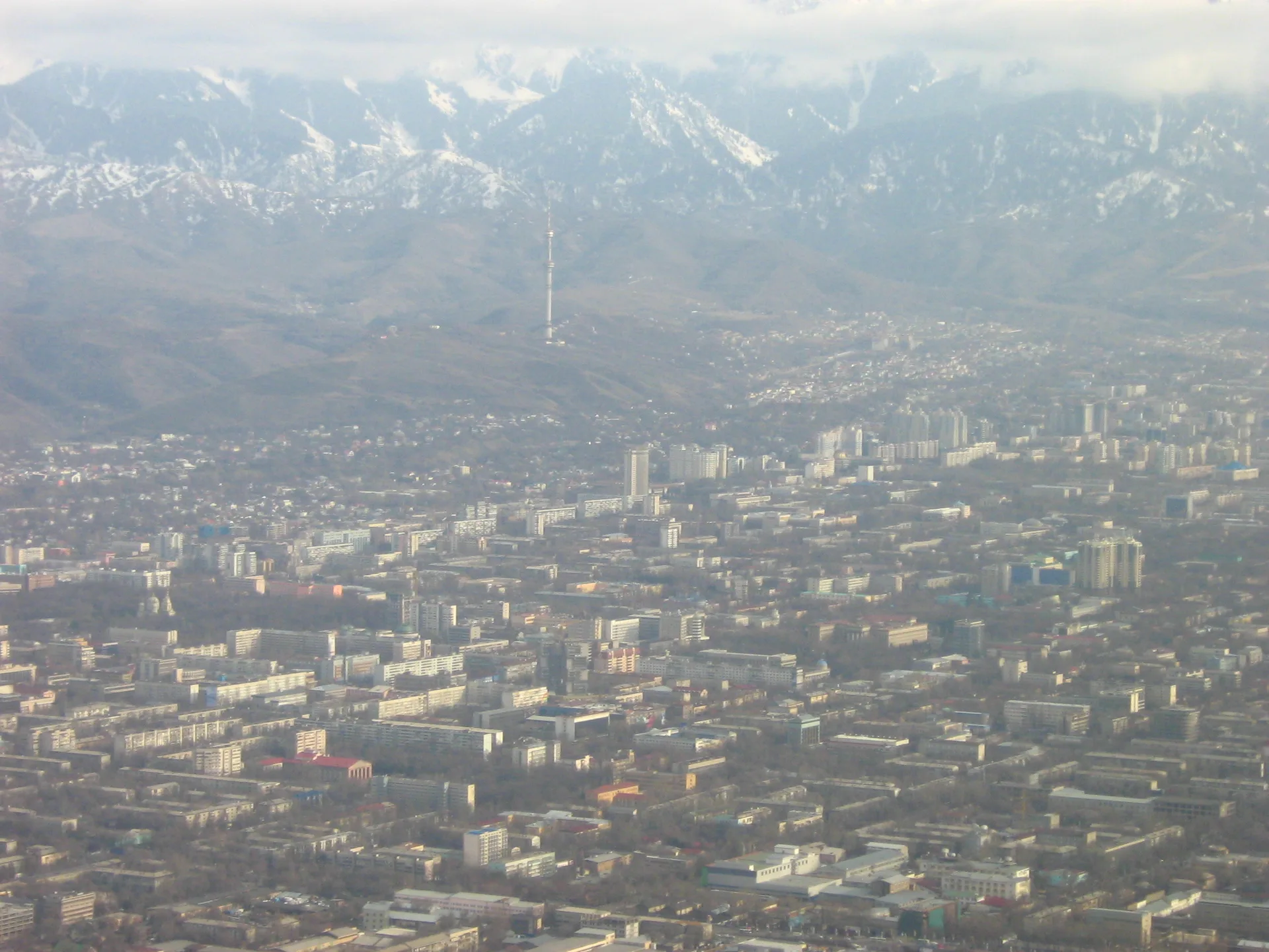 Aerial view of Almaty city spread across the foothills of the Trans-Ili Alatau mountains in Kazakhstan.