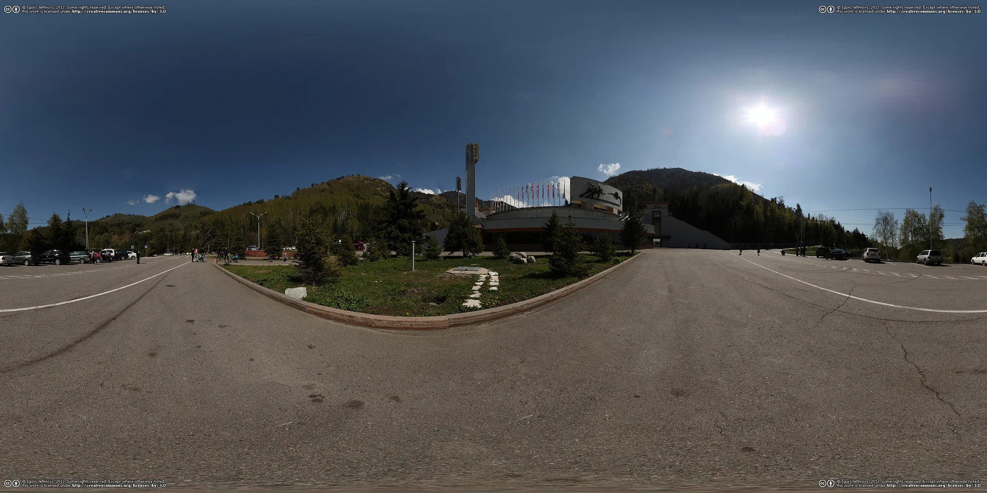 Panoramic view of the Medeu high-altitude ice rink complex surrounded by the Zailiisky Alatau mountains, with the mudflow-protection dam visible above the stadium.