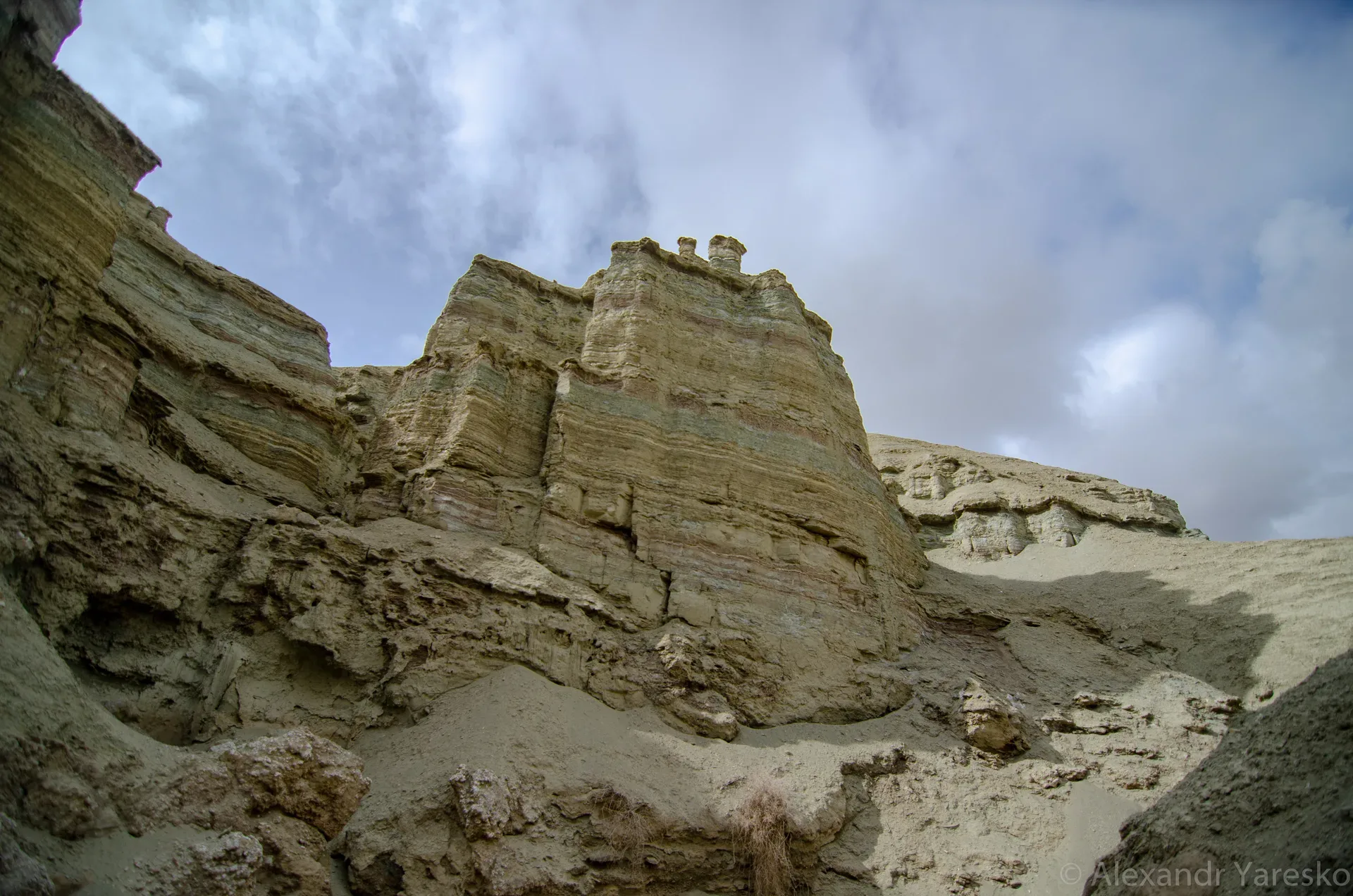 Panoramic view of the chalk Aktau mountains in Altyn-Emel, pale white and cream sedimentary escarpment rising from the flat desert valley floor, photographed April 2016