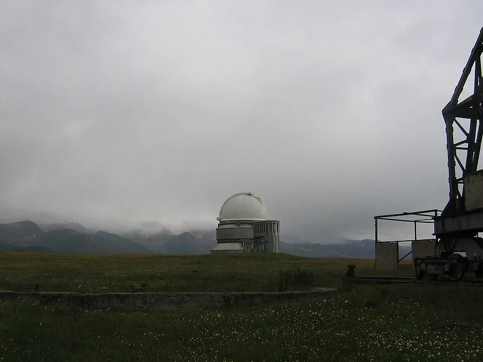 Context near Assy Plateau Jailau And Nomad Camps: White telescope dome of Assy-Turgen Observatory viewed from the open plateau road.