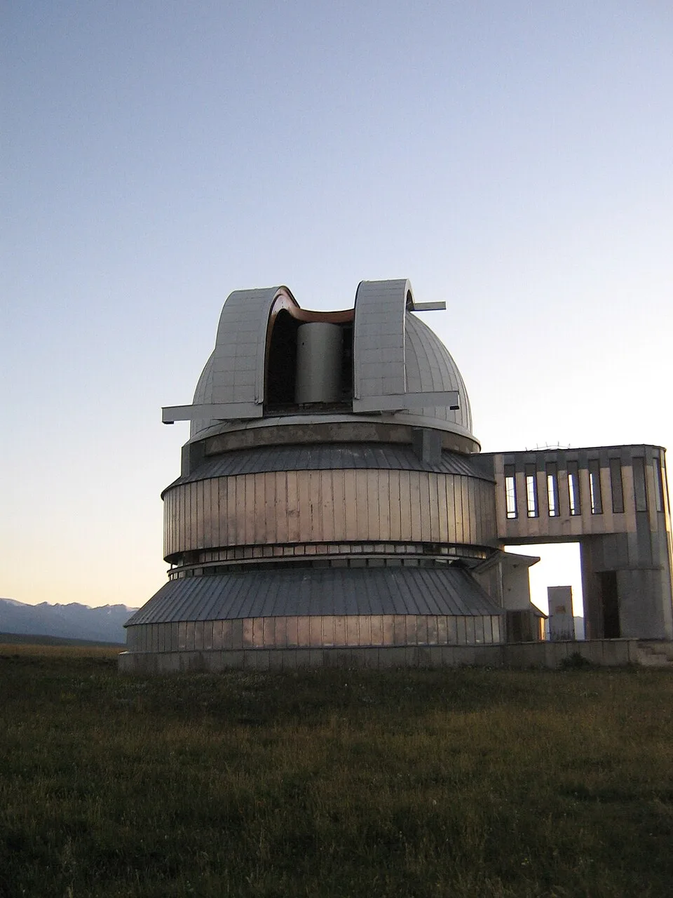 Observatory dome at Assy-Turgen with the telescope slit opened against the mountain sky.