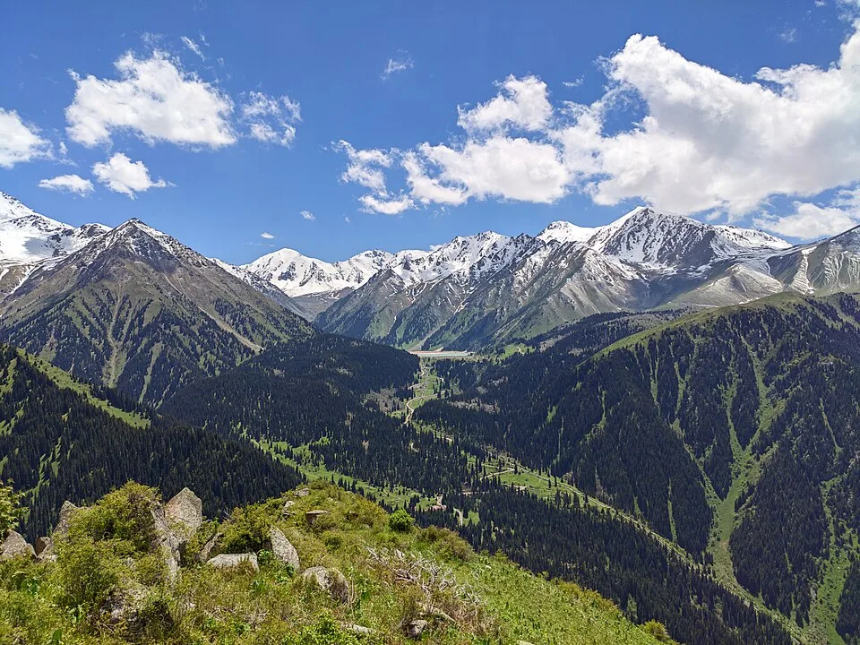 Serpentine road climbing toward Big Almaty Lake above the gorge checkpoint area.