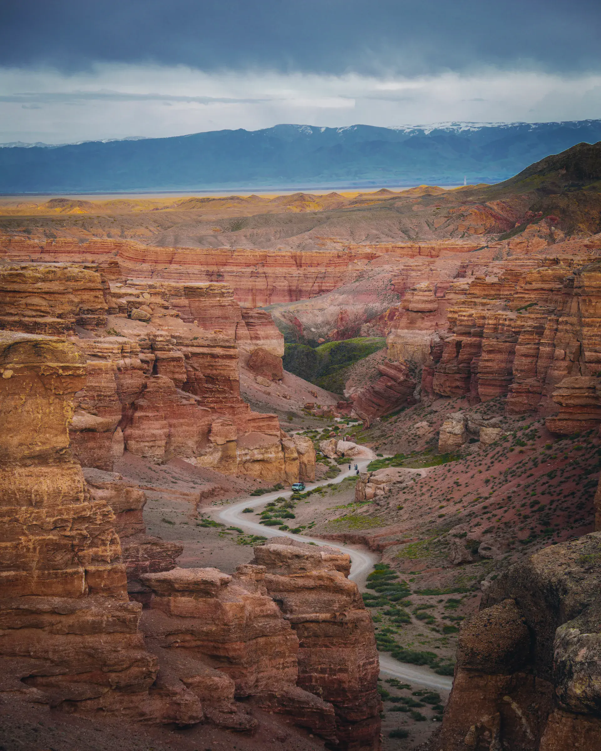 Road descending through red rock formations inside Charyn Canyon.