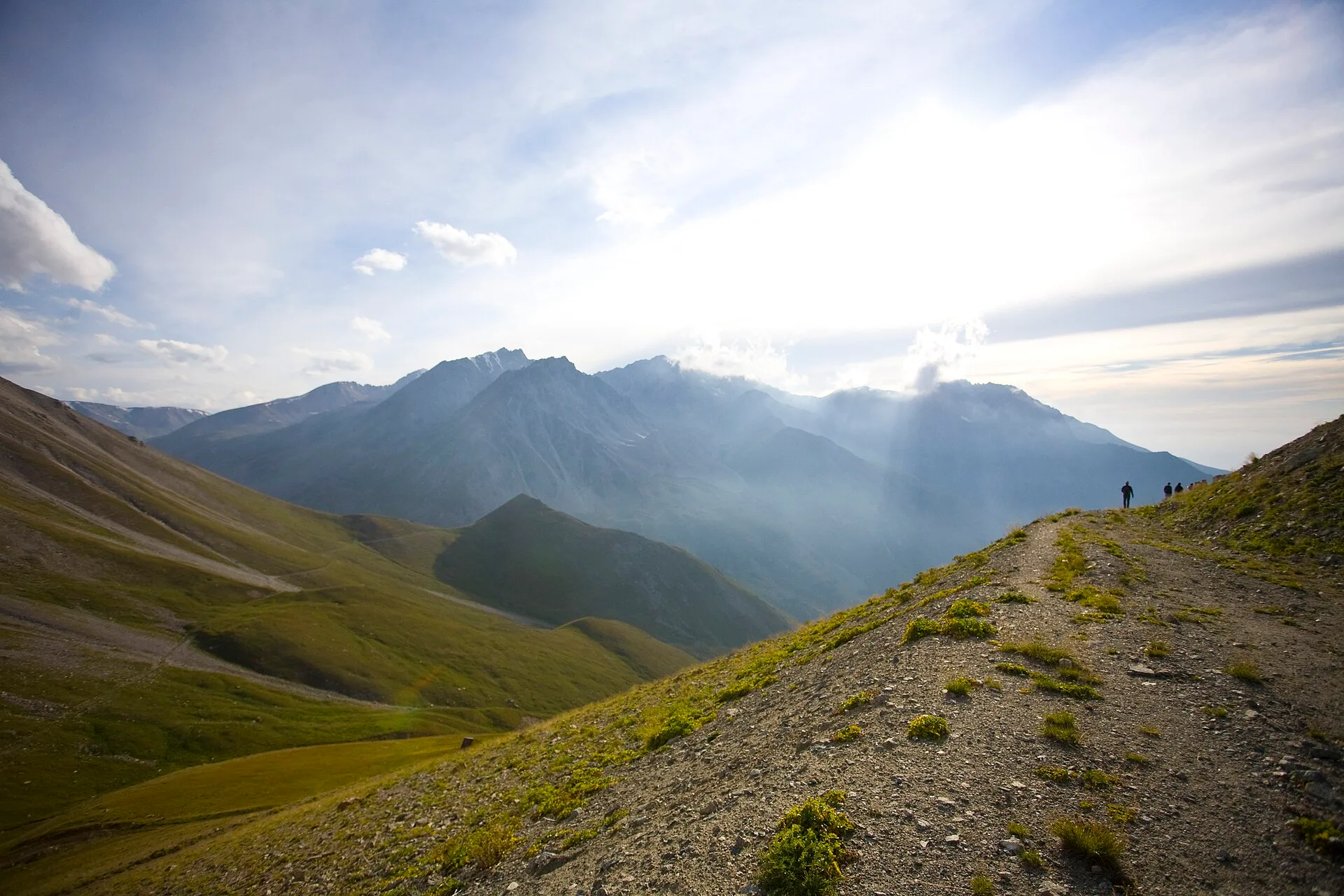 Spruce-covered slopes inside Ile-Alatau National Park beyond the entrance area.