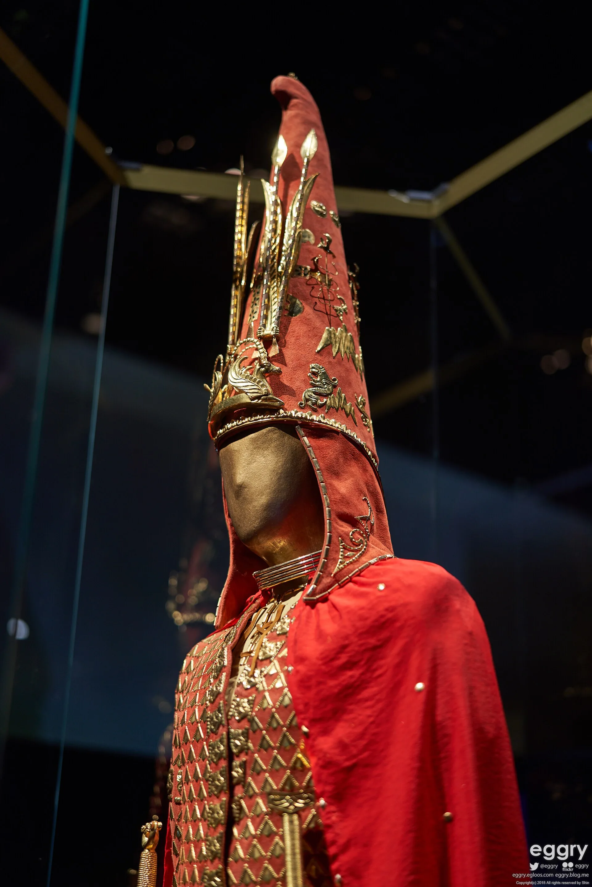 Detailed view of the Golden Man conical headdress with gold ornaments.