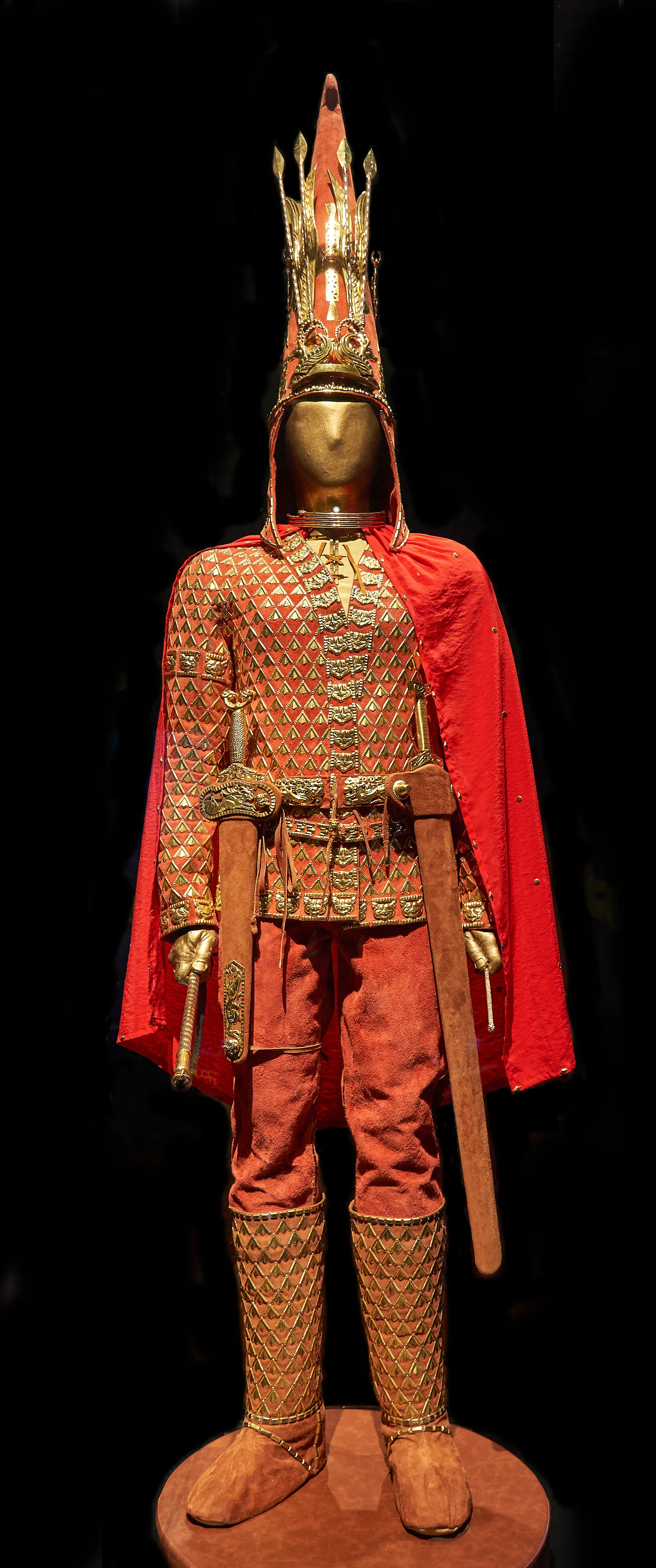 Golden Man reconstruction with tall headdress and gilded armor from the Issyk burial.