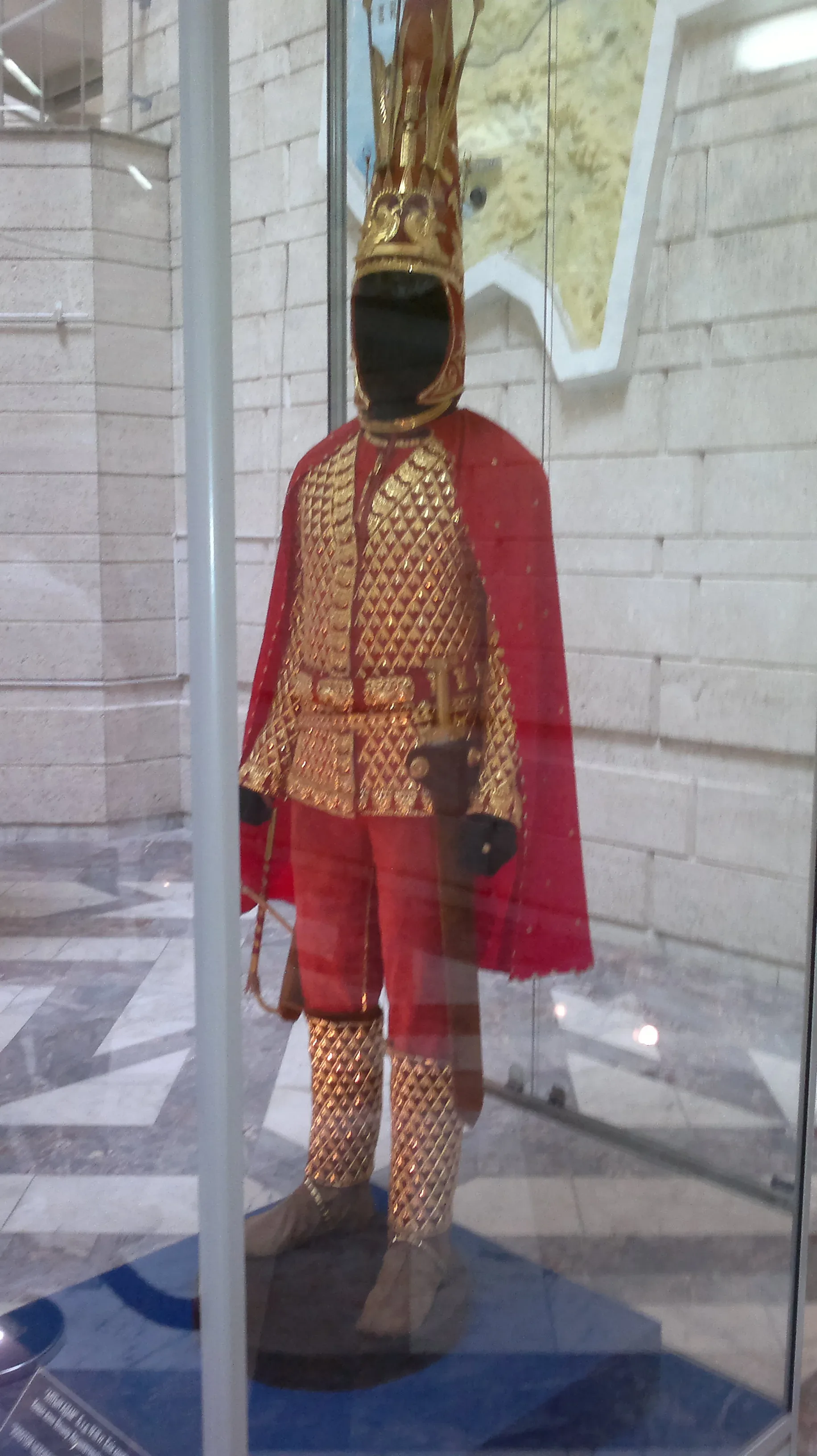 Golden Man reconstruction on display in the Central State Museum of Kazakhstan, showing full-length gilded armour suit with conical headdress