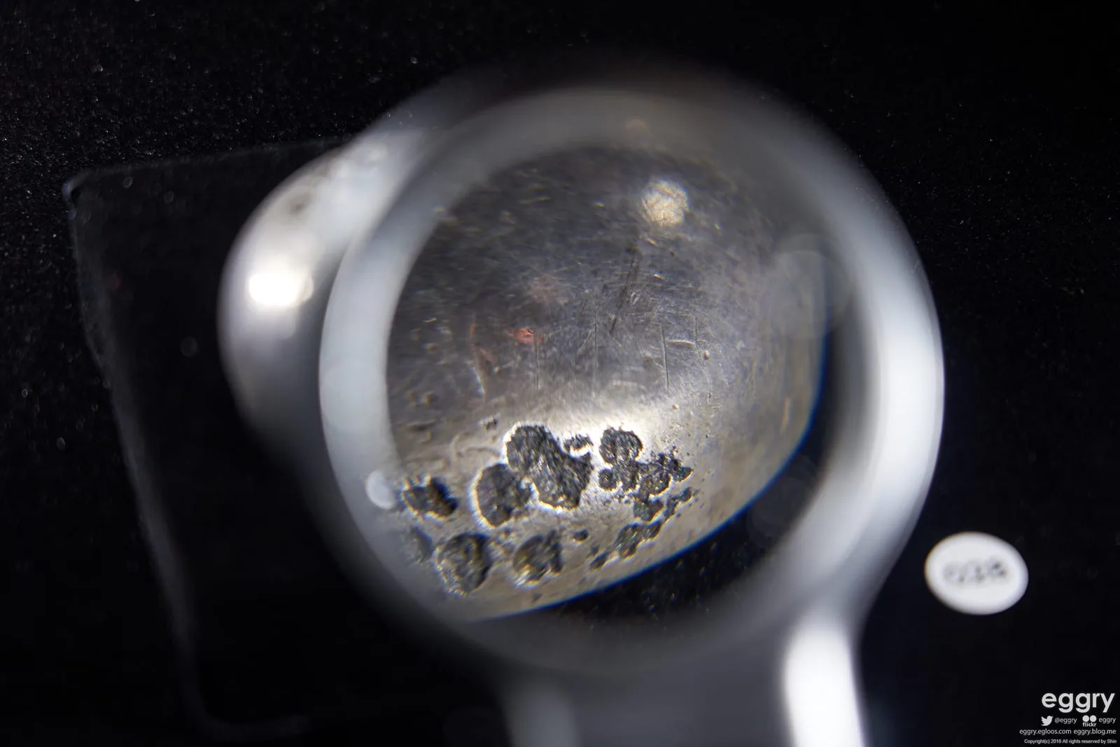 Context near Issyk Kurgan Field: Inscribed bowl from the Issyk kurgan displayed against a dark background.