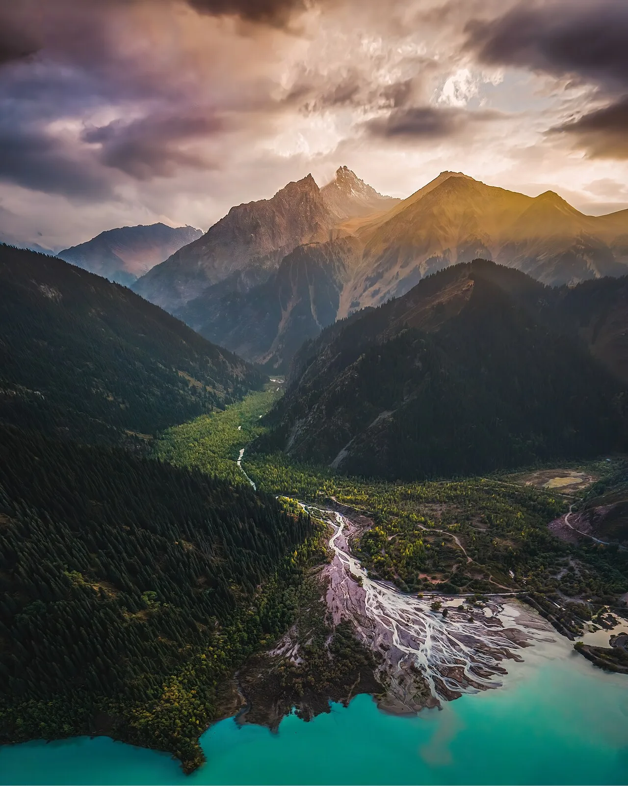 Aerial view of the river channel entering Issyk Lake through pale sediment.