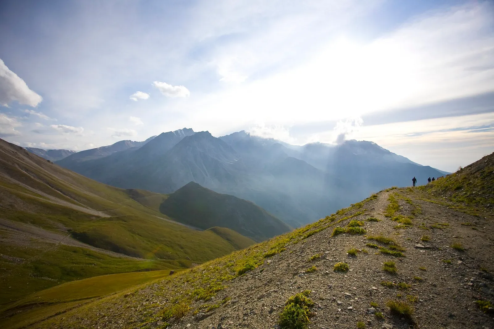 Context near Issyk Lake: Spruce-covered slopes inside Ile-Alatau National Park beyond the entrance area.