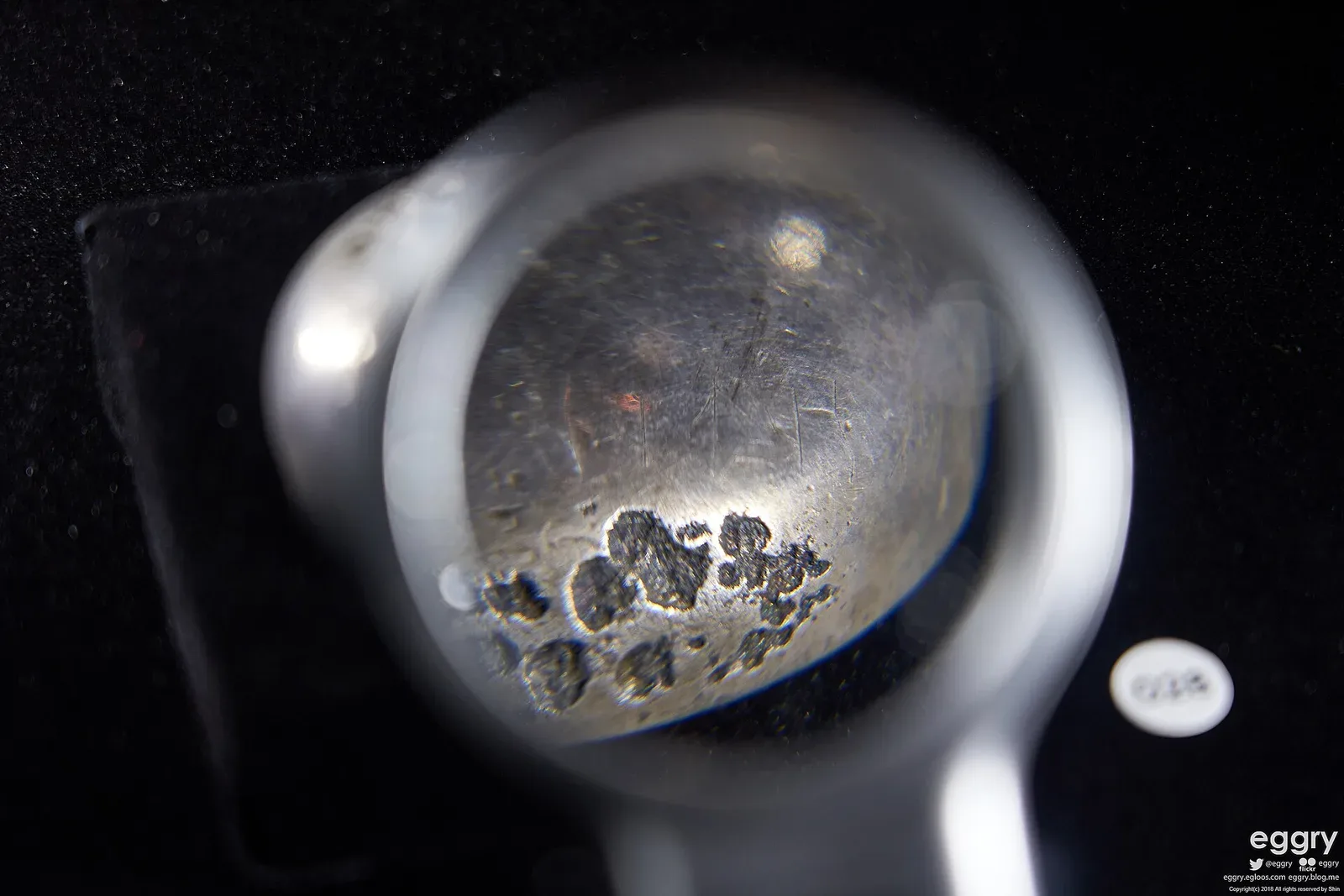 Context near Issyk Yesik Golden Man Museum: Silver bowl from the Issyk kurgan display showing the undeciphered inscription.