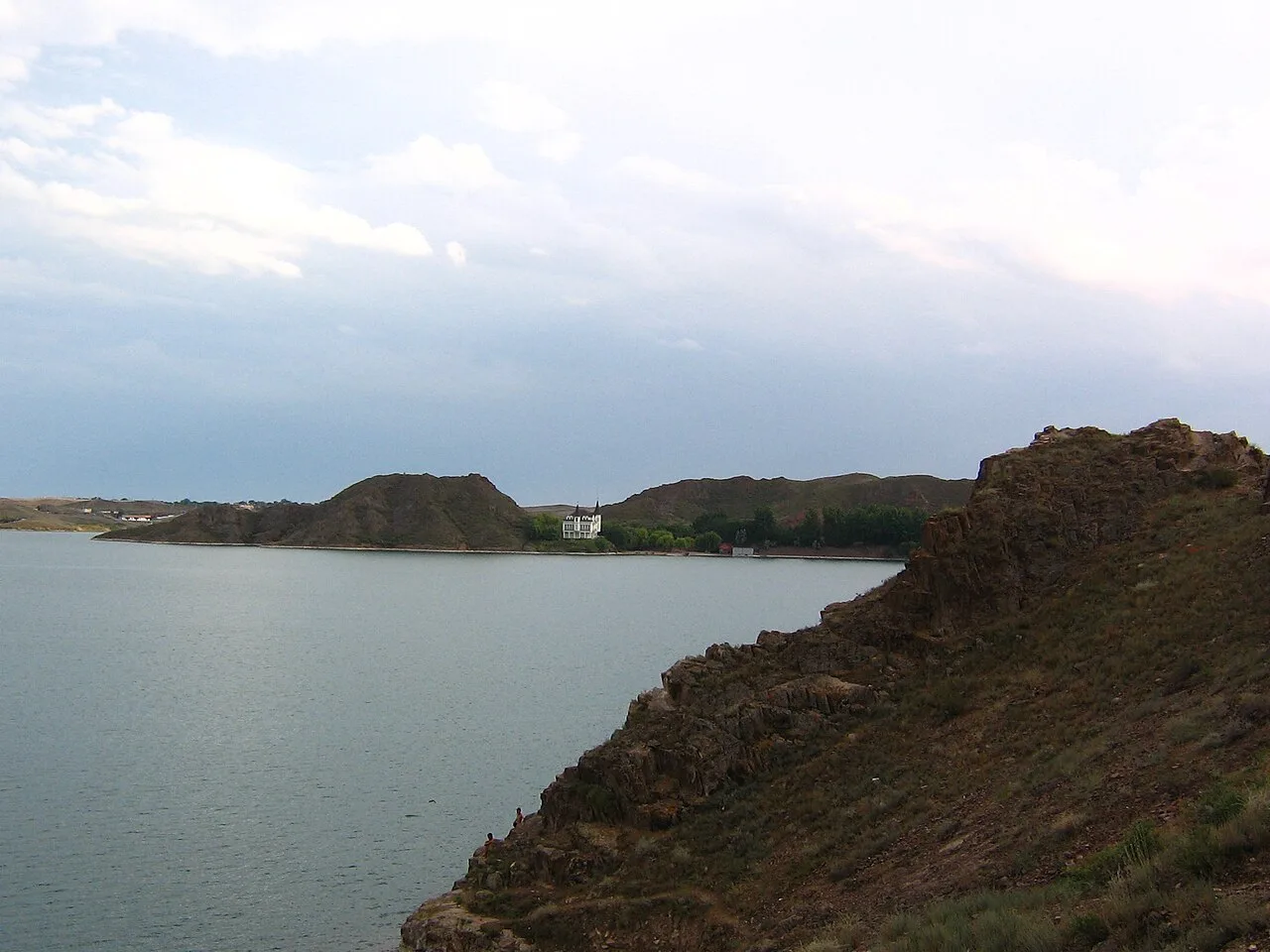 Open steppe road scene near Kapchagai reservoir, showing the dry terrain immediately after the crossing.