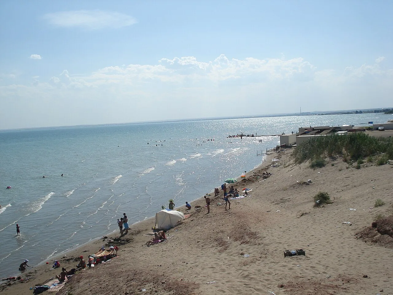 Open water of Kapchagai reservoir stretching toward the far shore in clear summer light.