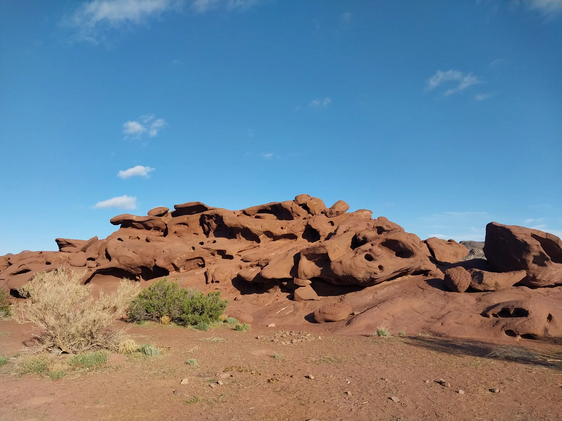 Solidified lava formations in the Katutau Mountains, with dark volcanic rock broken into rough outcrops.