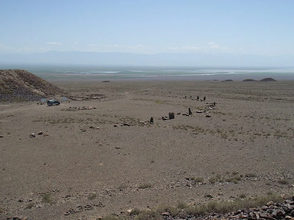 Context near Katutau Volcanic Basalt Ridge: Low Saka burial mounds on the open Altyn-Emel steppe at the Besshatyr necropolis.