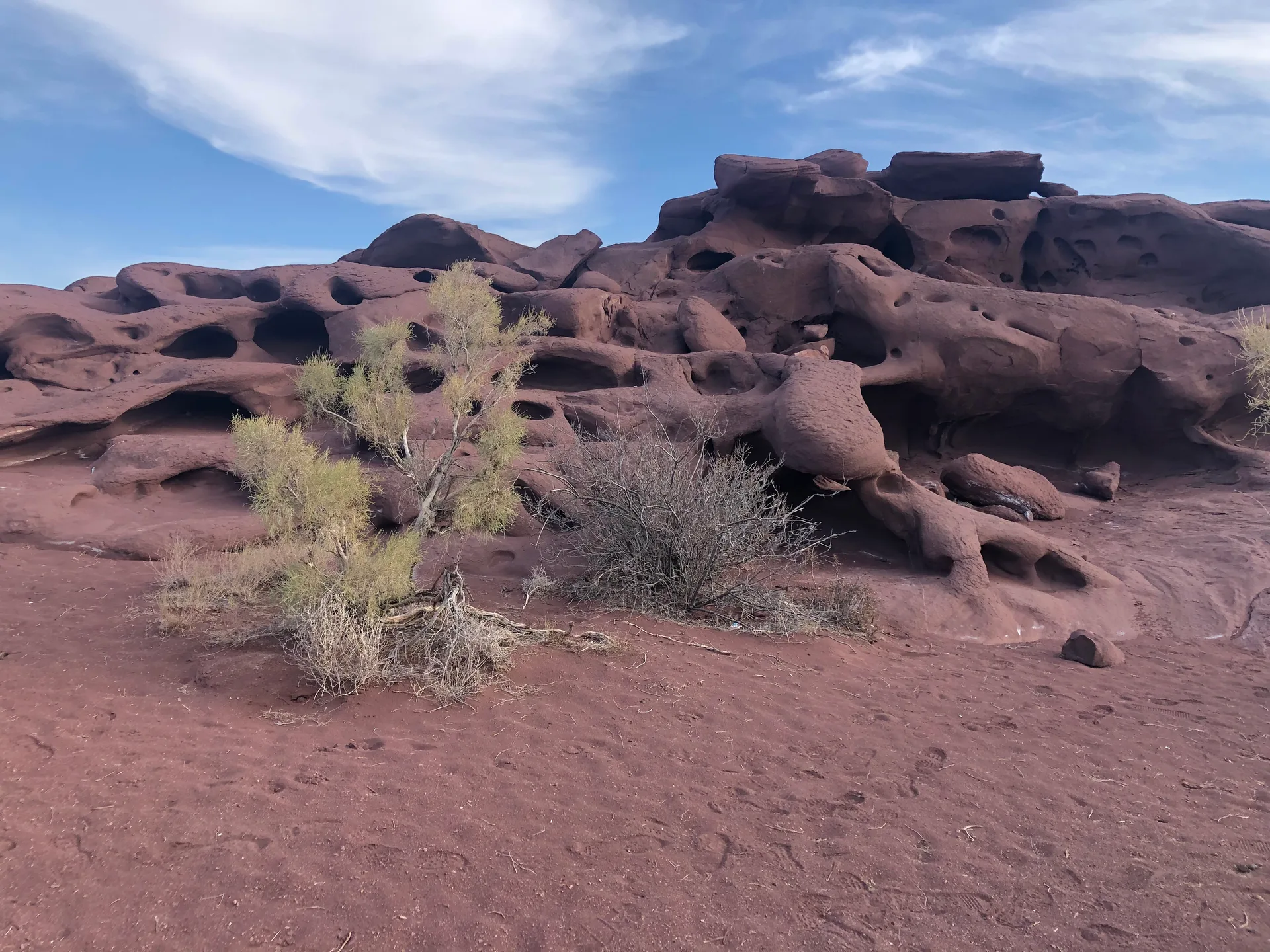 Volcanic slope in Katutau with dark basalt rock scattered across a dry hillside under open sky.