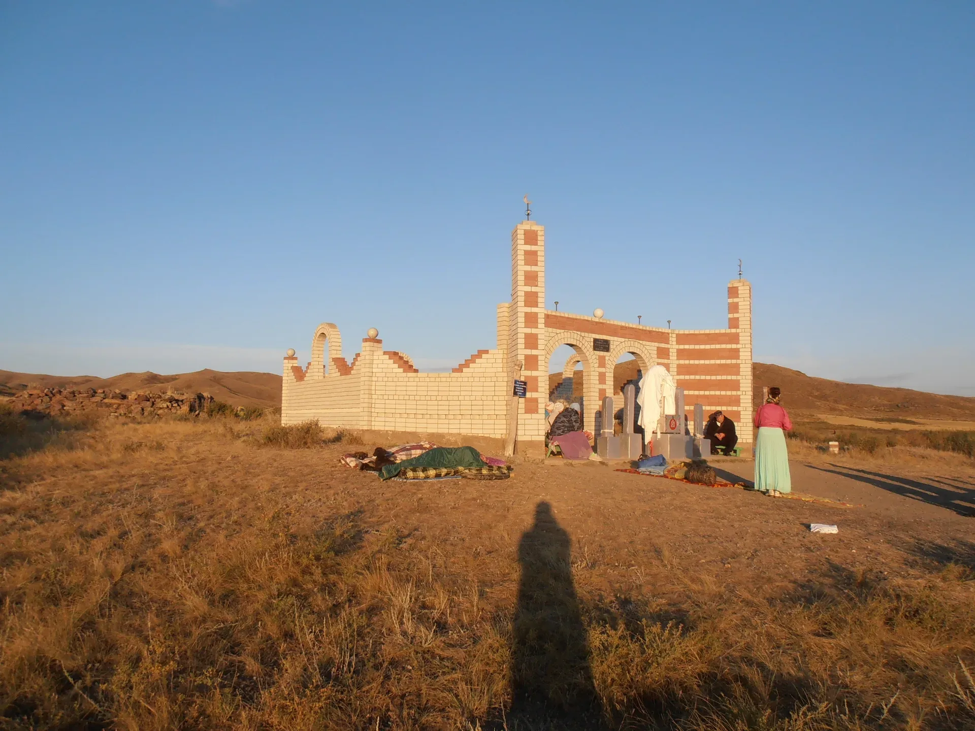 Front view of Bayanbai mausoleum in eastern Kazakhstan, a brick-built Kazakh vernacular dome-on-drum funerary structure in an open steppe setting