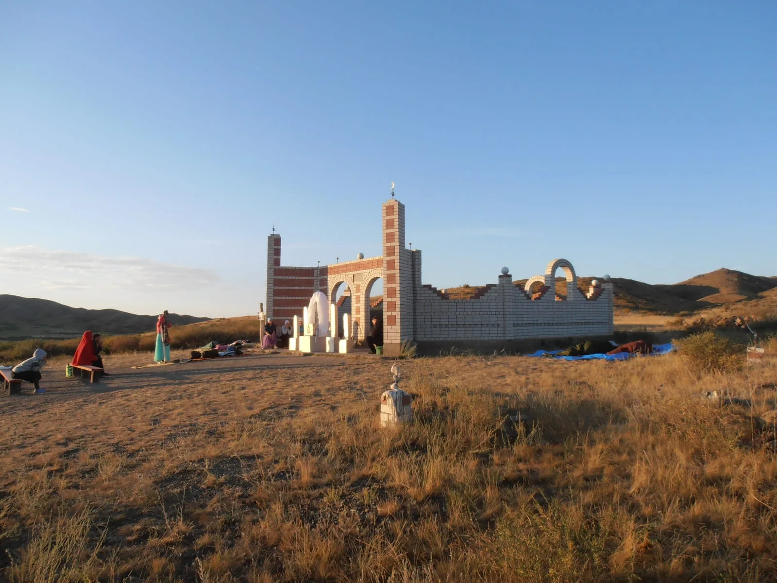 Context near Kegen: Front view of Bayanbai mausoleum, a brick dome-on-drum funerary structure used as a kesene reference.