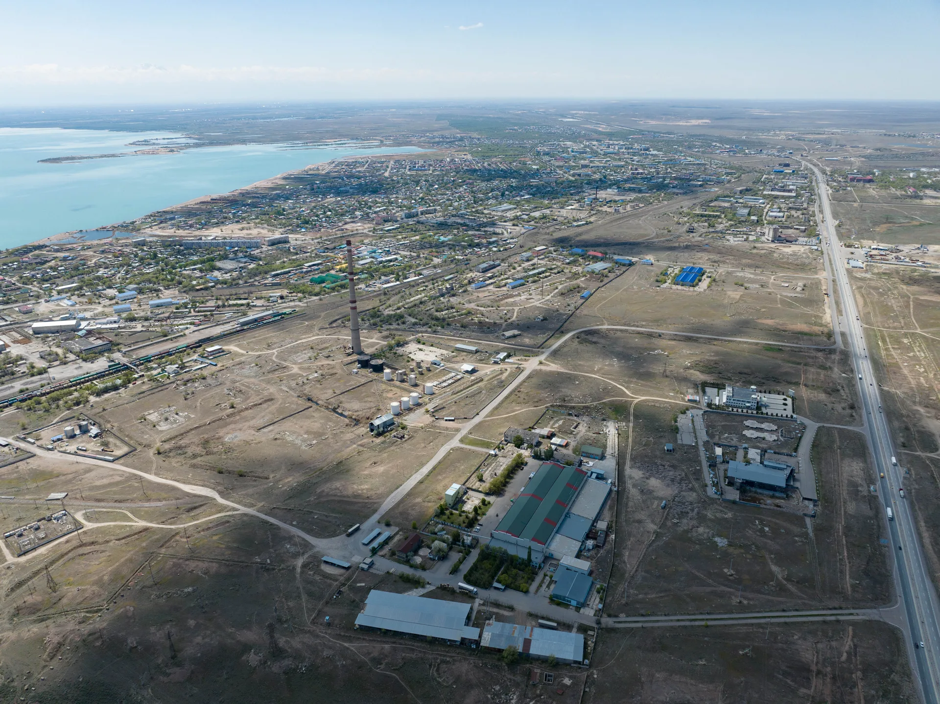 Aerial view of Konaev city blocks near the Kapchagai reservoir, showing the urban supply stop from above.
