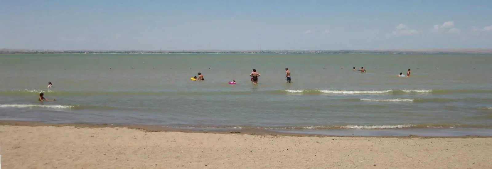 Context near Off Road Track To Eshkiolmes Ridge Approach: Wide Kapchagai Reservoir crossing on the long road route from Almaty toward Tekeli.