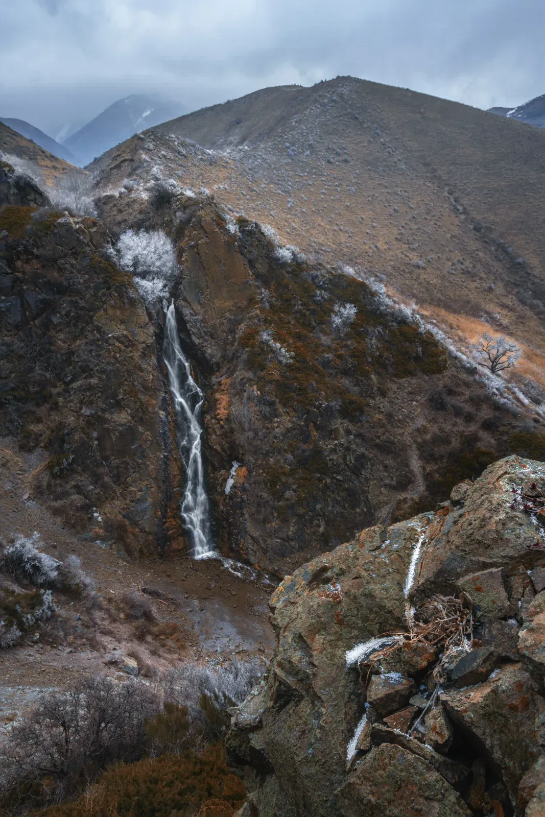 Context near Park Ecopost And Trout Farm: Medvezhiy Bear Waterfall dropping through a narrow green Turgen Gorge rock basin.