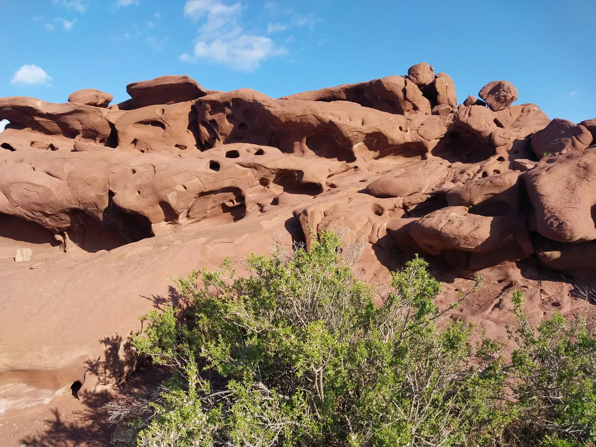 Katutau lava mountain ridges in Altyn-Emel seen from the park track, dark volcanic formations rising above open steppe on the drive back toward Basshi
