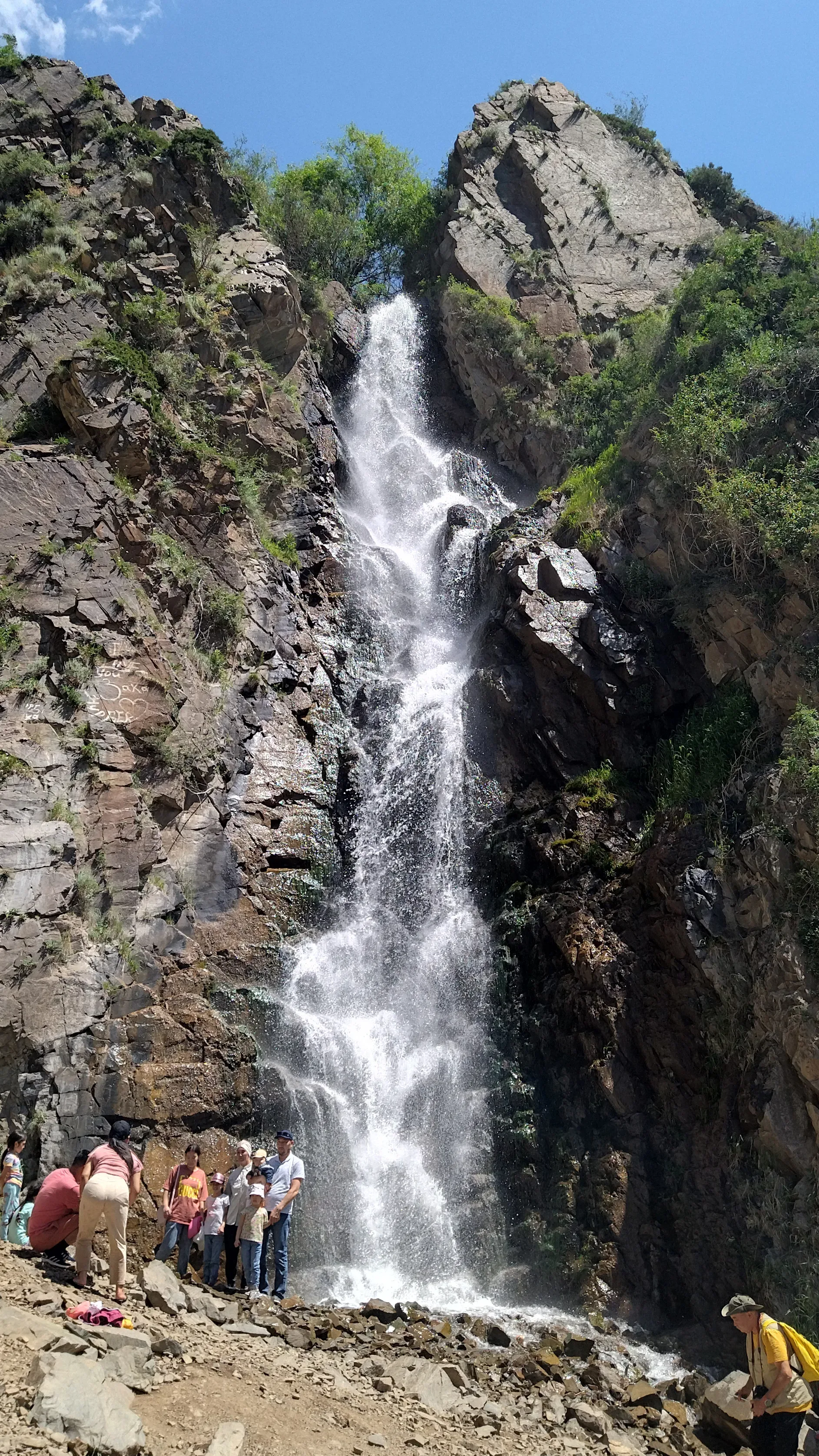 Bear Falls waterfall dropping through pine forest in the Turgen Gorge, Ile-Alatau National Park.
