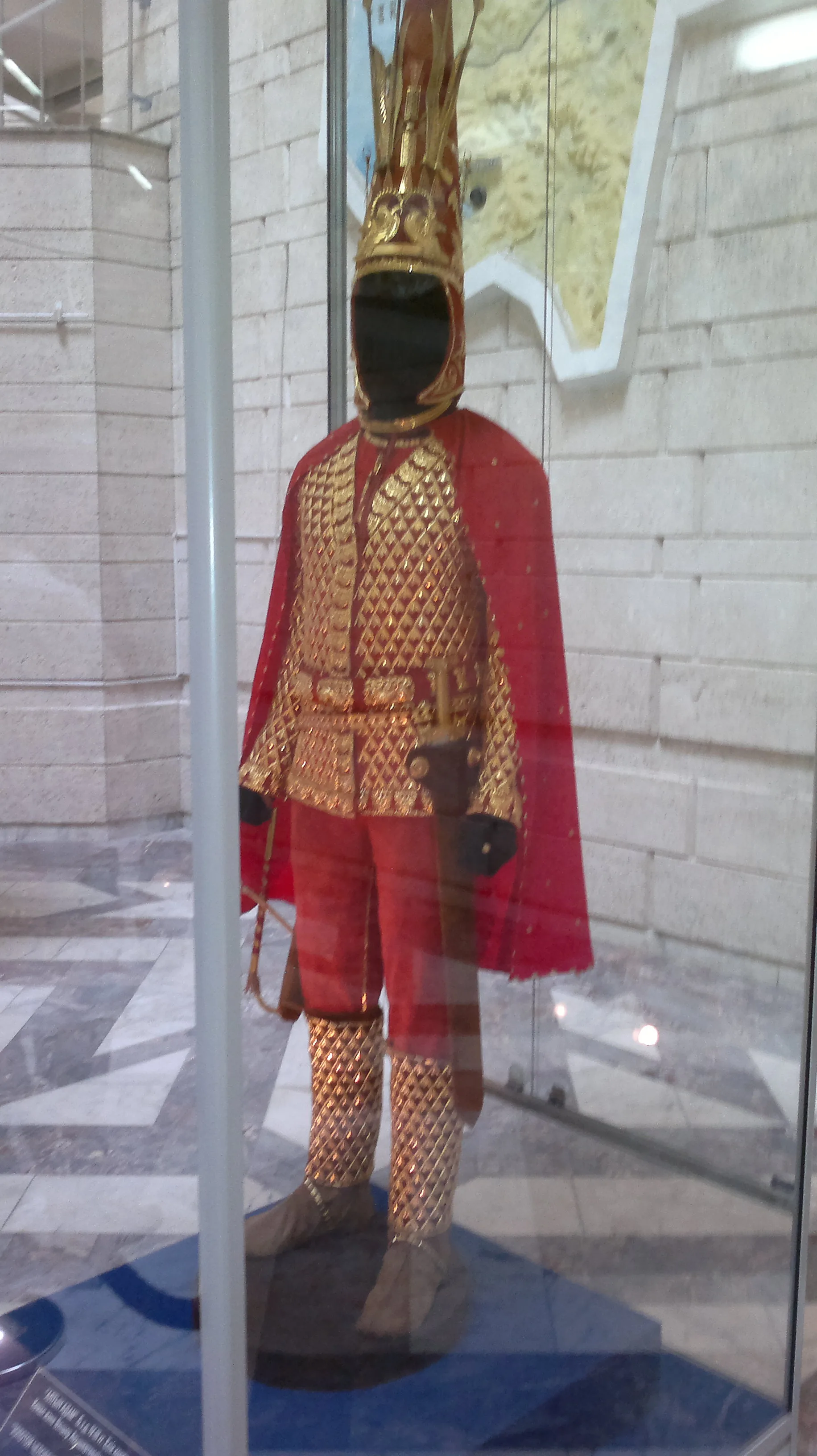 Golden Man reconstruction on display in the Central State Museum of Kazakhstan, showing full-length gilded armour suit with conical headdress